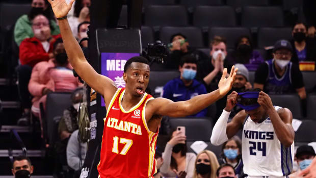 Onyeka Okongwu holds his arms up in the air after a dunk.